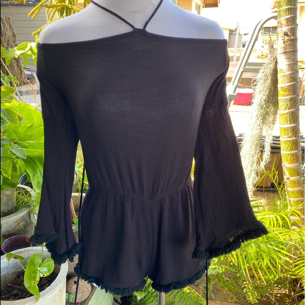 Black romper with trumpet sleeves and tassels